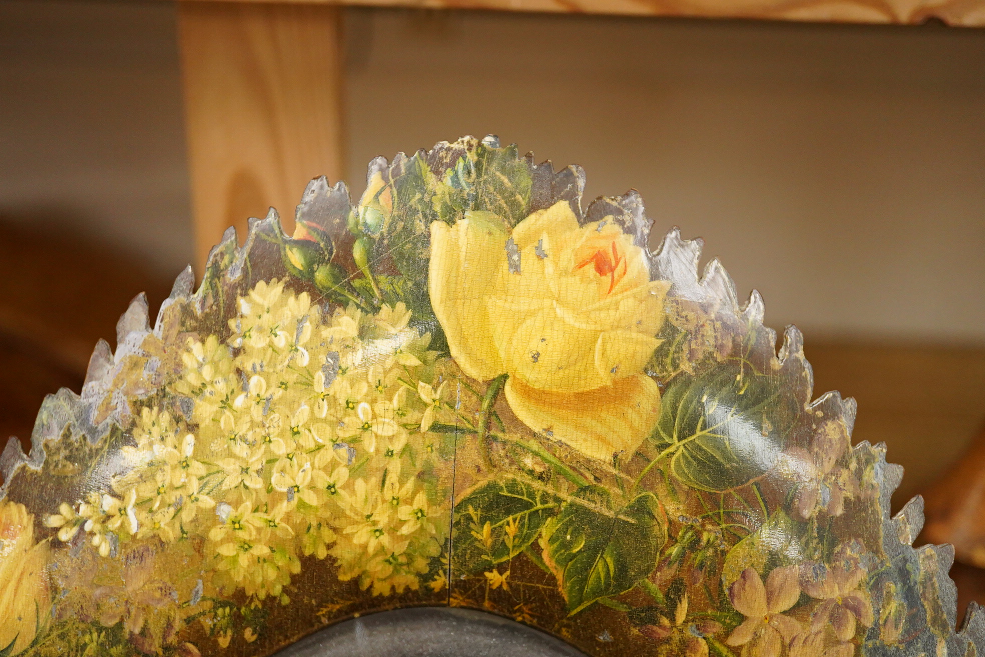 A dressing mirror, naturalistically designed with painted foliate decoration and branch effect legs, 42cm high